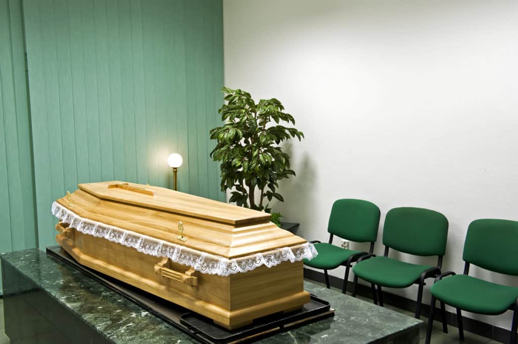 Funeral home interior with a classical wooden coffin.