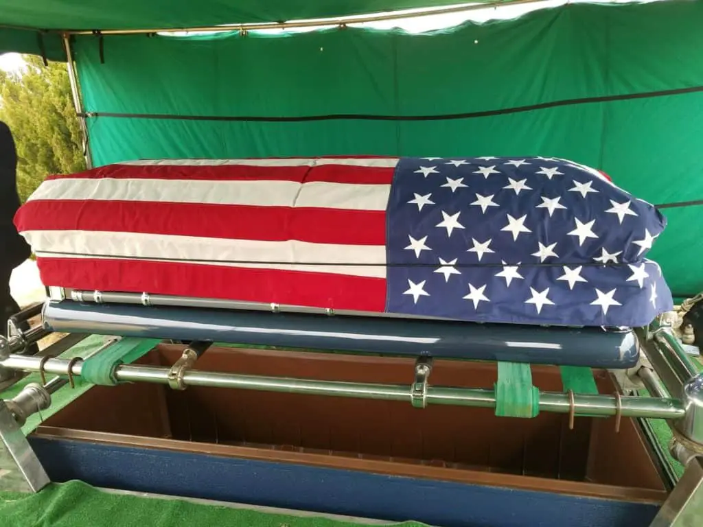 he US flag is draped over the casket for Burial after funeral A Honor for a Sailor.