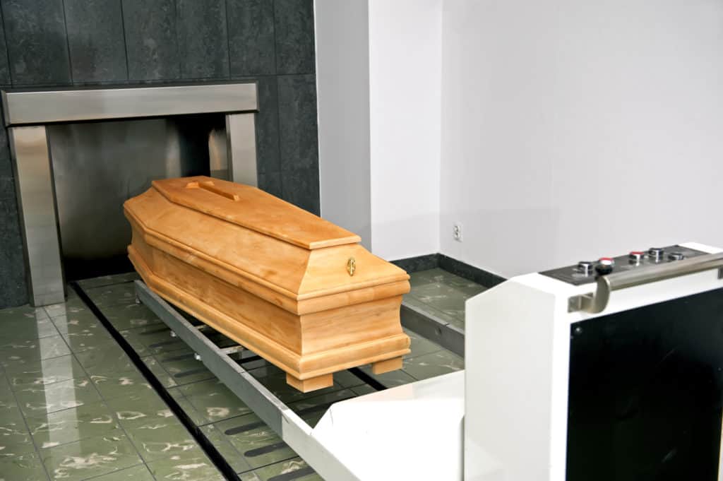 A wooden coffin in a contemporary crematory. Funeral service.