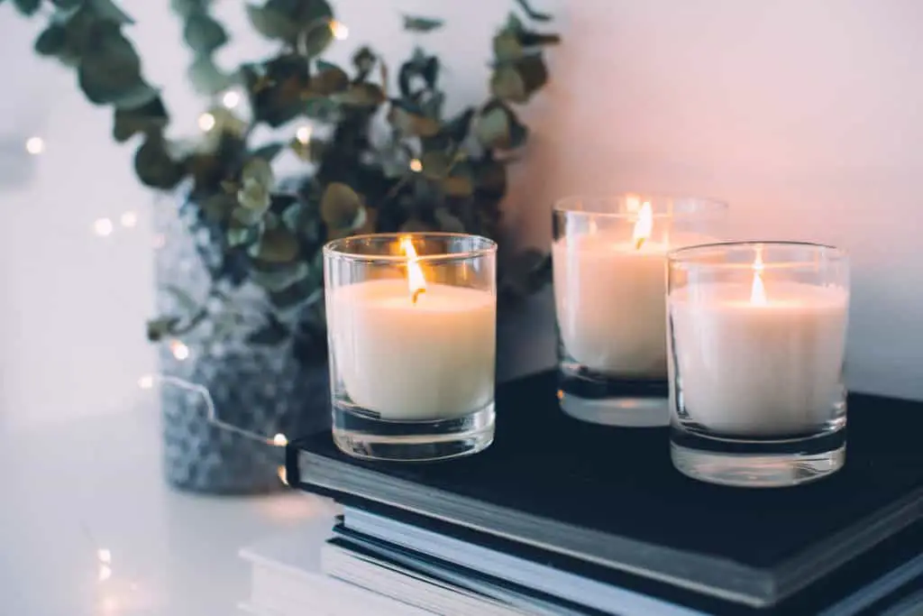 Cozy home interior decor, burning candles in evening room.