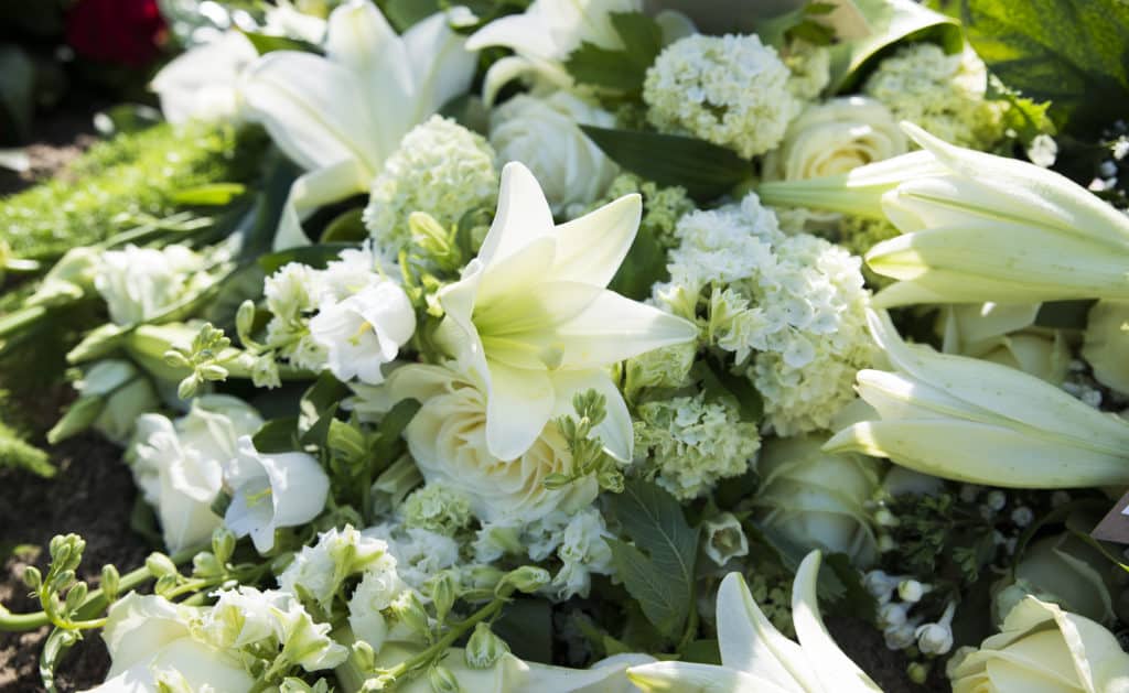 Bouquet with white funeral flowers as lily