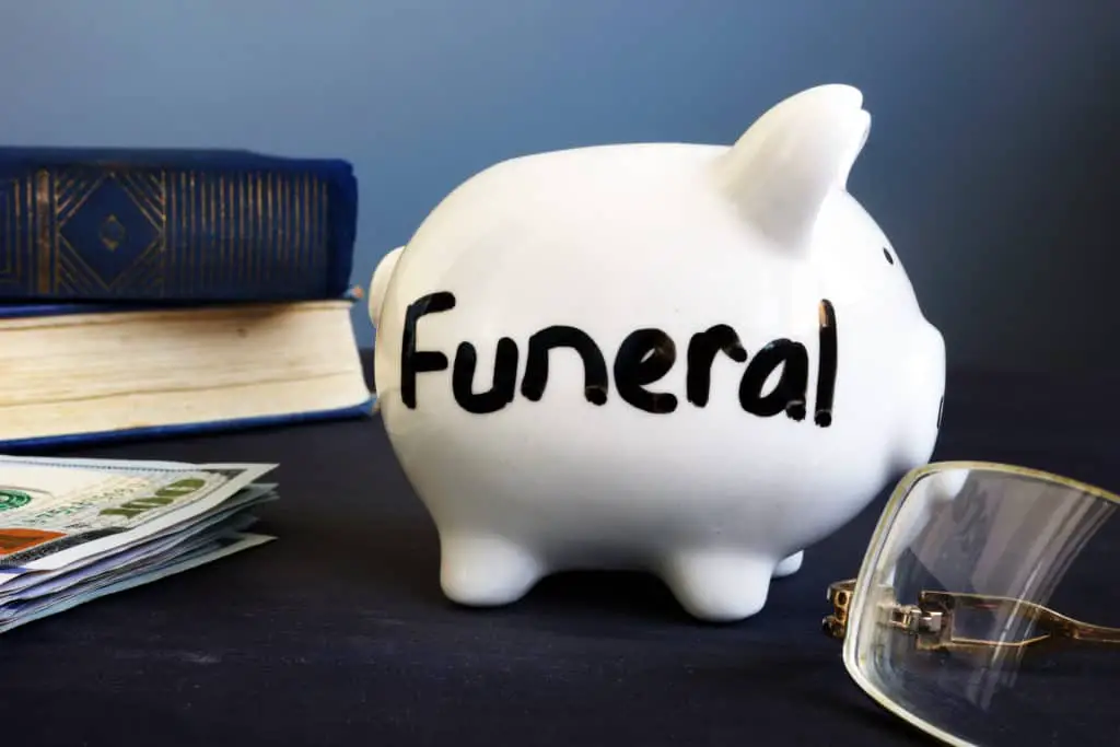 Funeral plan written on the side of piggy bank.